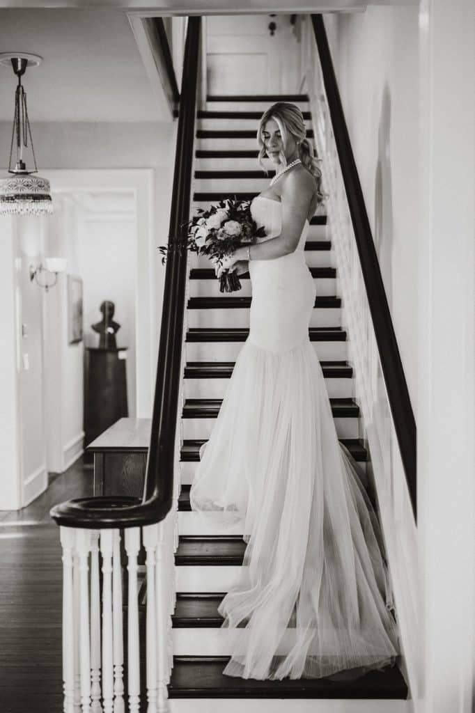 Torontali Photography an Orlando wedding photographer black and white image of bride on the staircase
