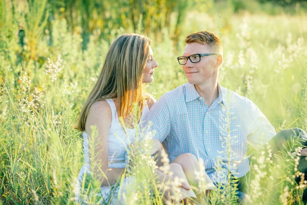engaged couple in a field photographed by Slone Photography, LLC