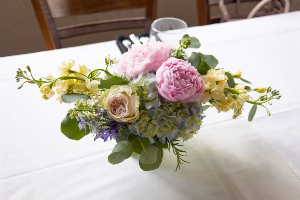 spring floral bouquet on white tablecloth at enzos on the lake in central florida