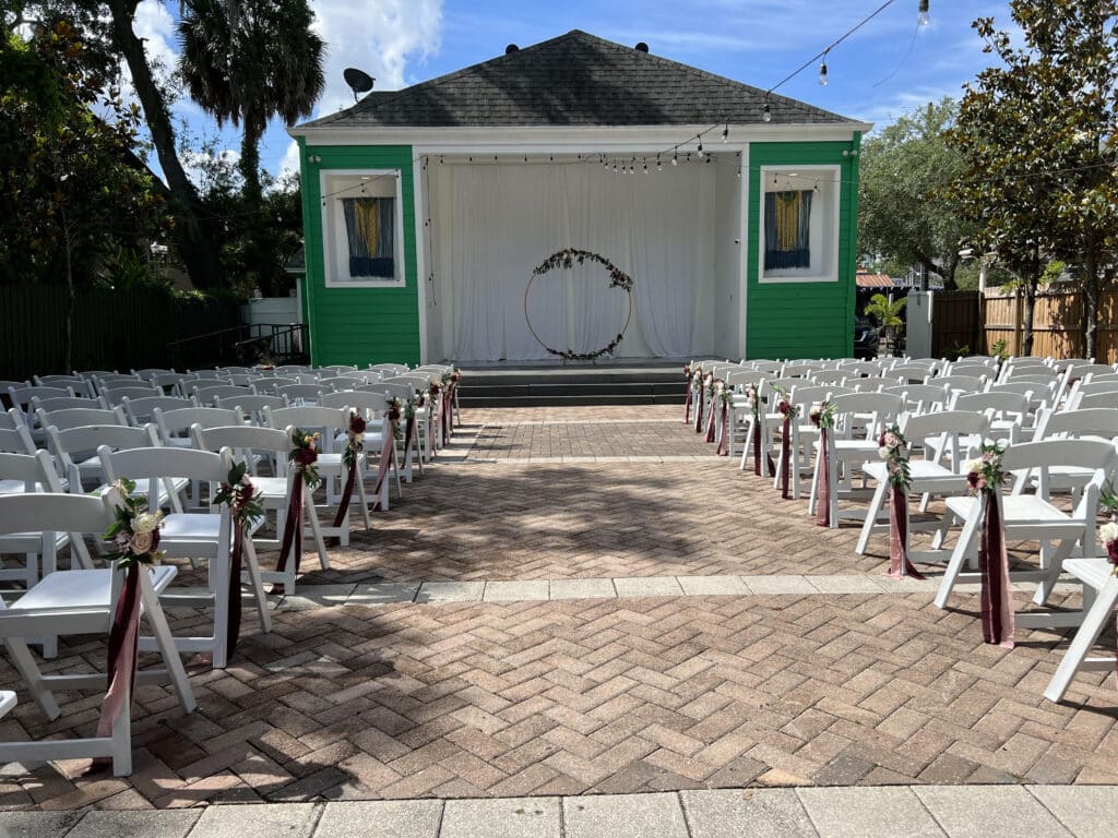 Wedding ceremony set up, with white chairs, center aisle leading up to a small building for the exchange of vows, Central, FL