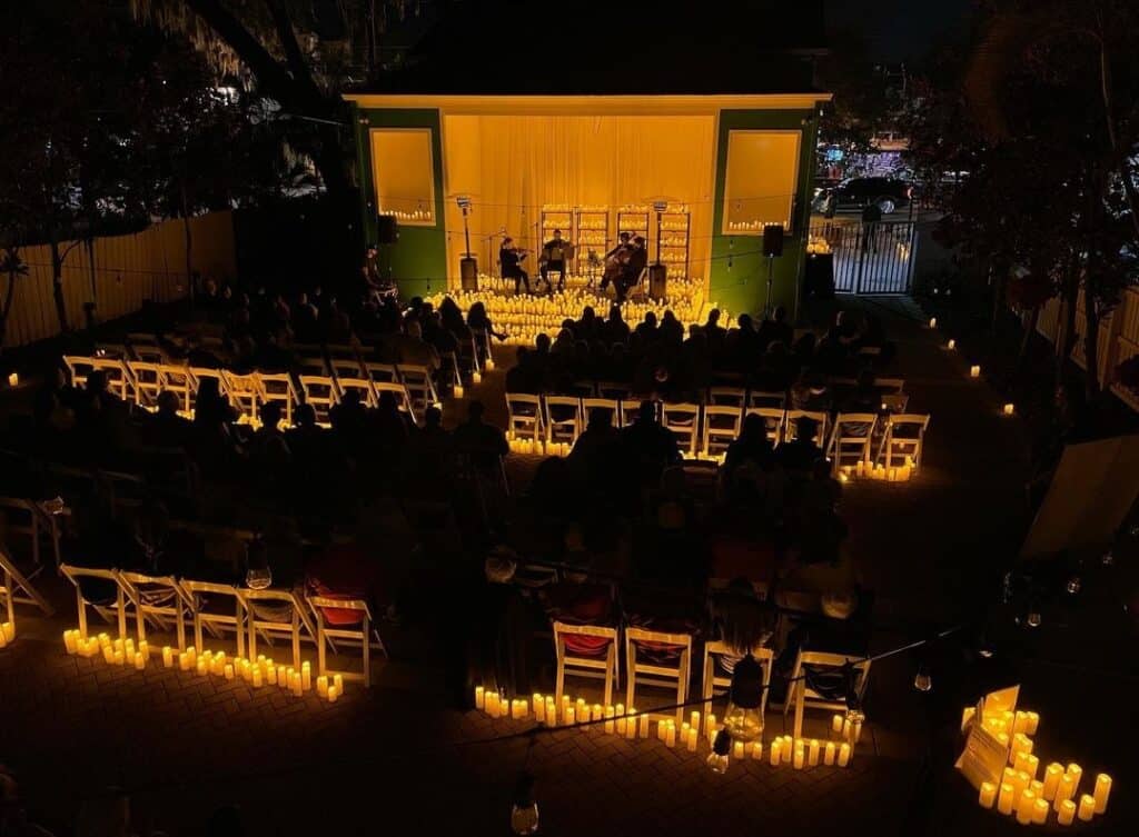 Different view of the outdoor ceremony area, in the evening, lit up with candles and soft lighting, Central, FL