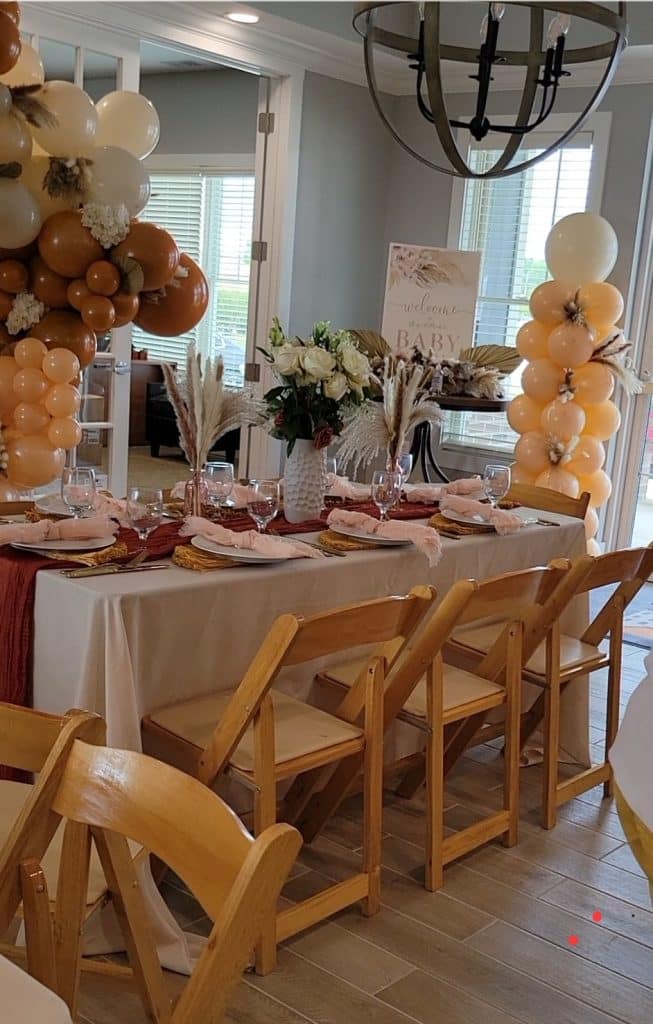 Different view of fall themed event, including a balloon tower with yellows and oranges, Central FL