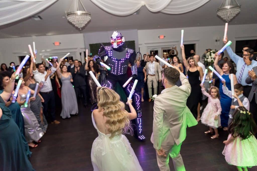 Guests use glow sticks on the dance floor to celebrate the happy couple, Kwik Entertainment