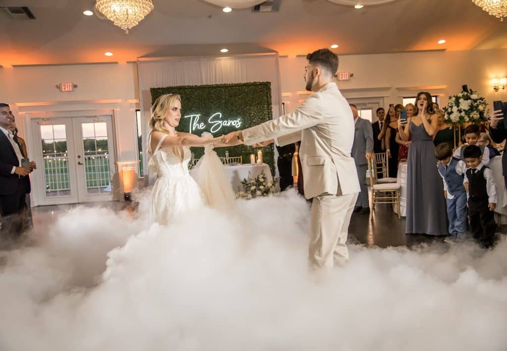 Bride and Groom dancing at their reception, with smoke in the foreground, guests watching on, Kwik Entertainment