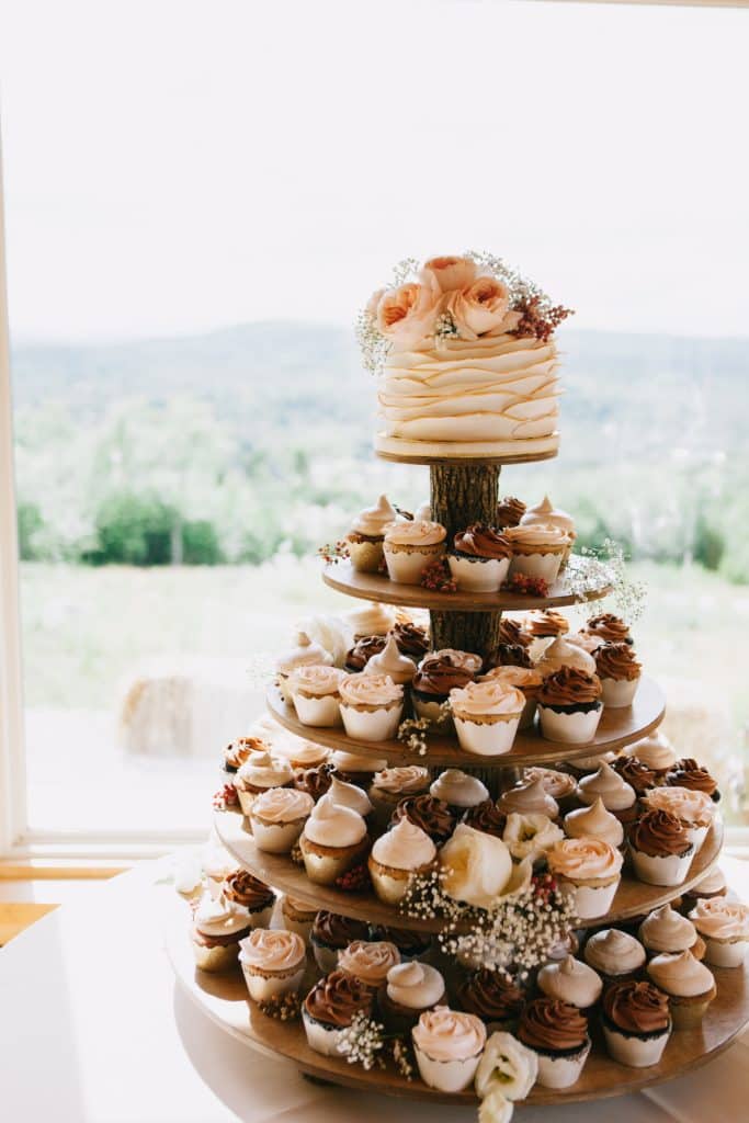 Cupcake tower with four tiers with a one layer cake on top, topped with flowers, Central, FL, The Naked Cupcake