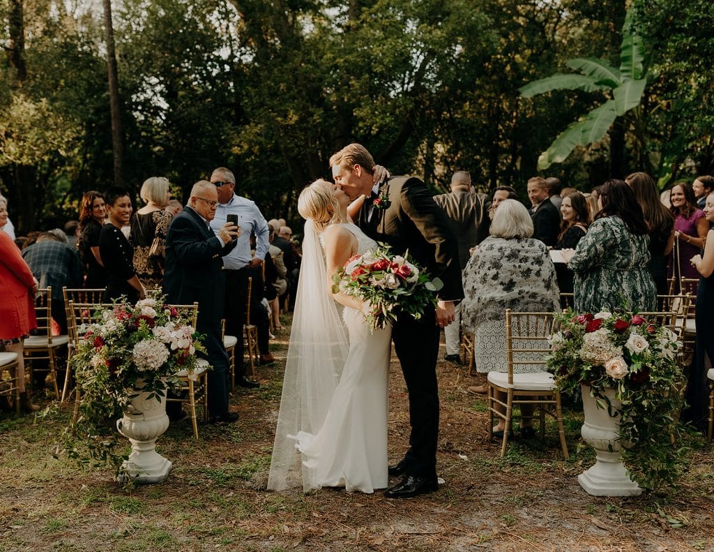 Outdoor ceremony, bride and groom, kissing as their ceremony concludes, Central FL