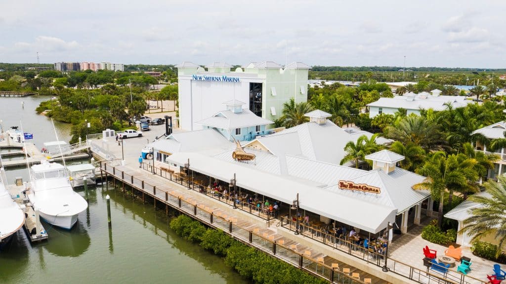 Aerial view of the restaurant with a tent on their patio, near the water, Outriggers Tiki Bar & Grille, Central FL