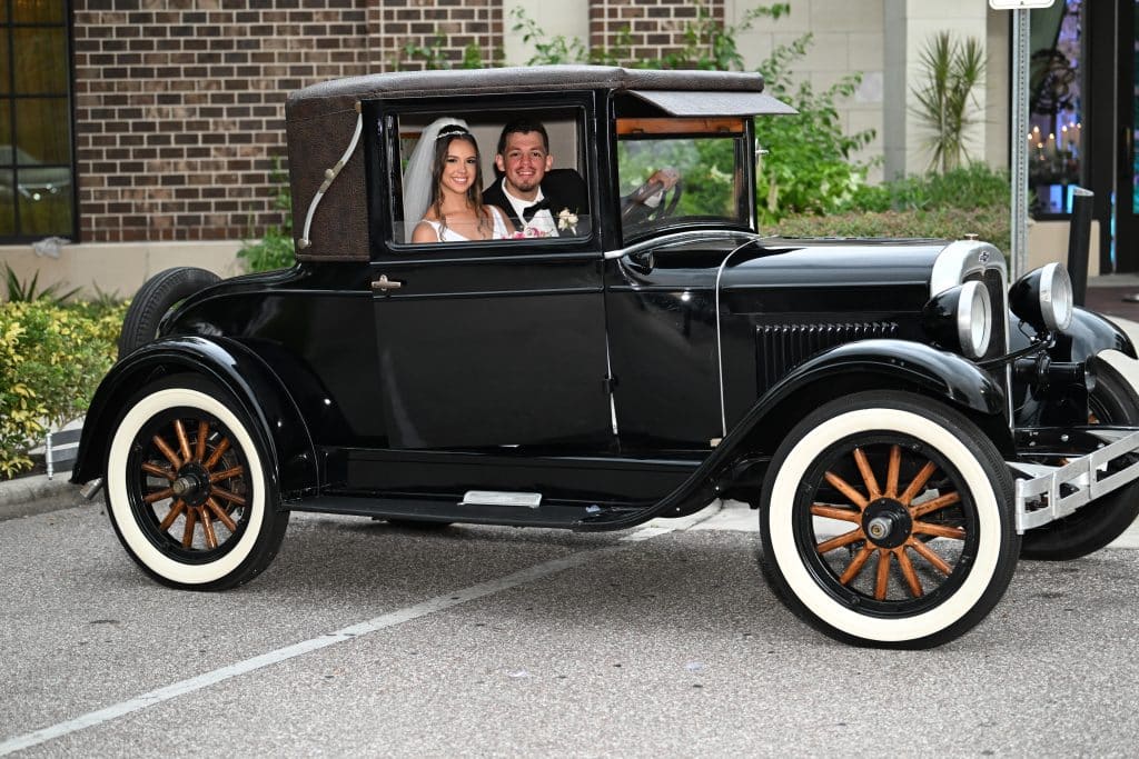 Wedding couple in an old fashioned black car, JB's Cinematic Creations and Photography, Central FL