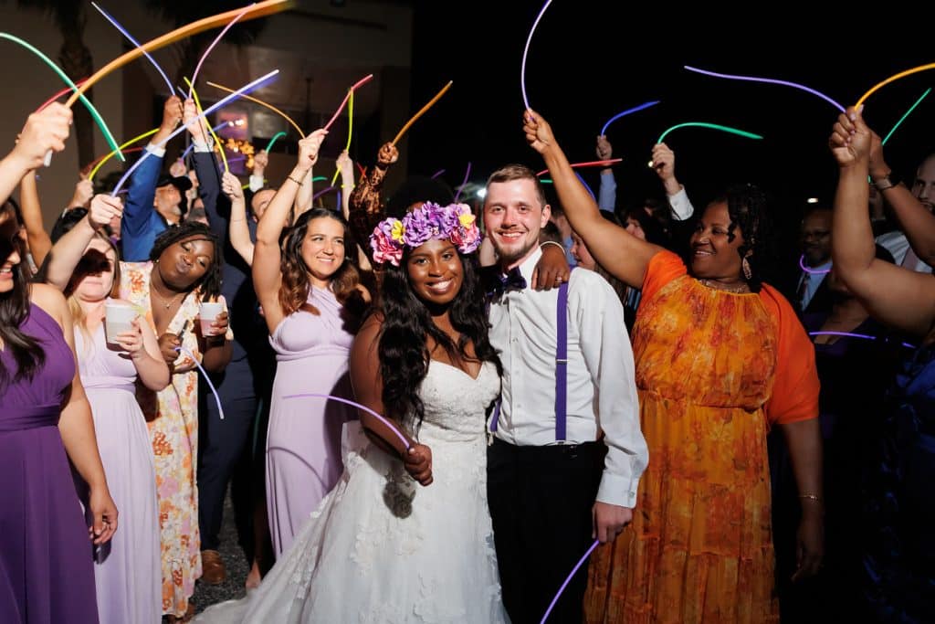 Bride and Groom posing with their guests surrounding them with glow sticks in their receiving line, Central FL