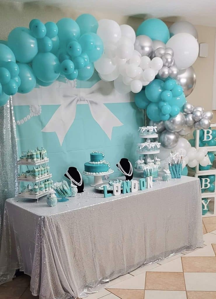 Baby blue themed baby shower with a dessert table decorated with a baby blue, white and silver balloon arch surrounding it and blue backdrop, JoJo's Glitz & Glam Event Planning, Central FL