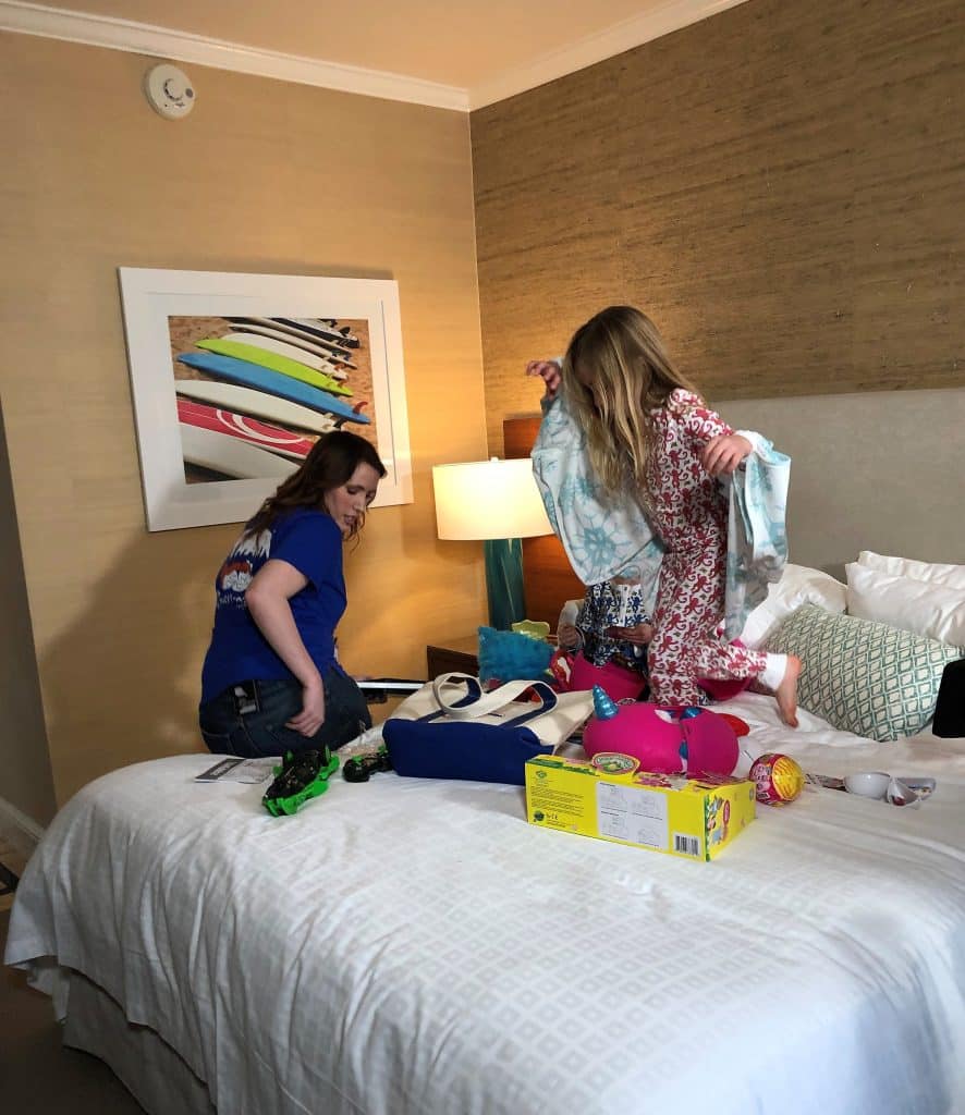 games and toys on the bed in a hotel room, ready for babysitters, Central FL