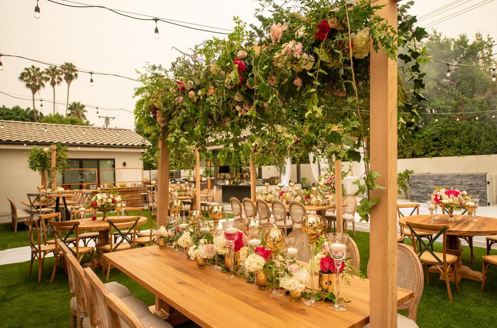 Garden party set up with a grand display of flowers hanging from the top of the overhead wooden poles, Casear Event Rentals Orlando, Central FL