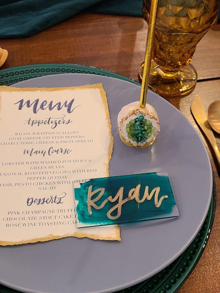 flat lay of a name plate, menu card, cake pop on a blue plate atop a table, Special Treats by Tanya, Orlando, FL