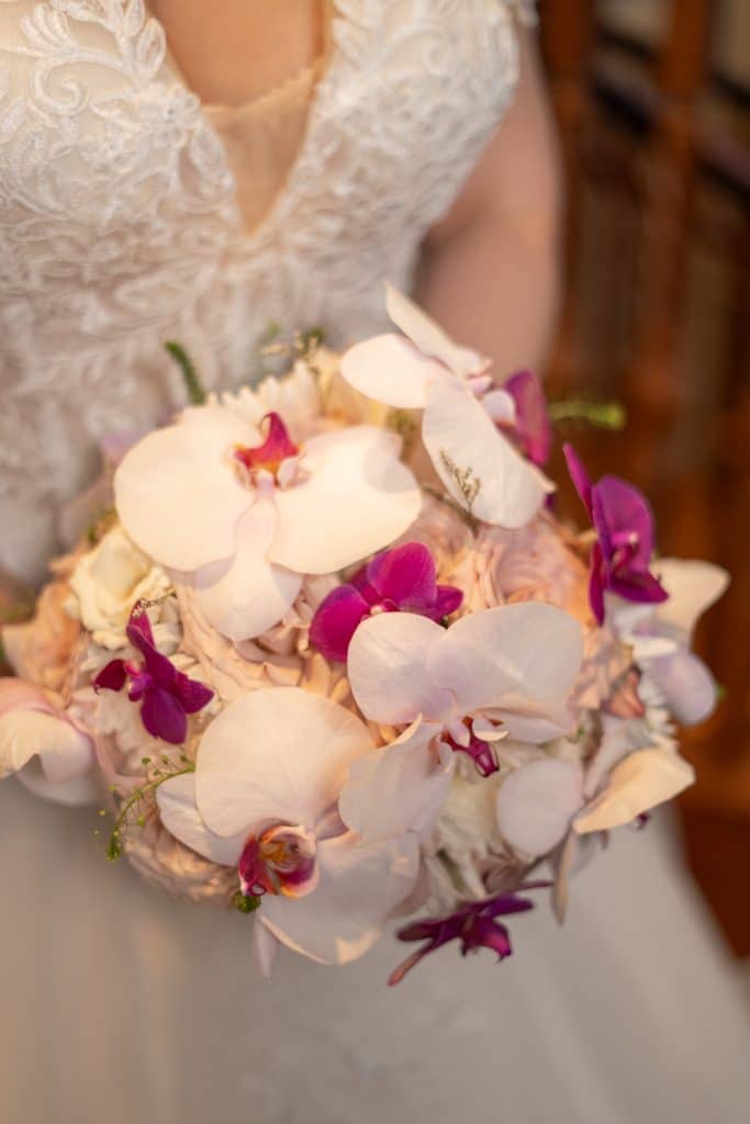 Close up of a hawaiian themed floral bouquet, held by its bride, JF Events and Flowers