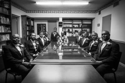 Wedding party seated at a large wooden table in their suits, Central, FL, JB's Cinematic Creations and Photography