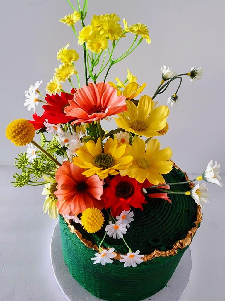 special cake with green fondant and gold border, topped with a beautiful bouquet of colorful flowers, Special Treats by Tanya, Orlando, FL