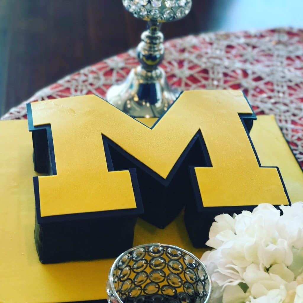 Cake in the shape of the letter M, decorated with yellow fondant, Special Treats by Tanya, Orlando, FL