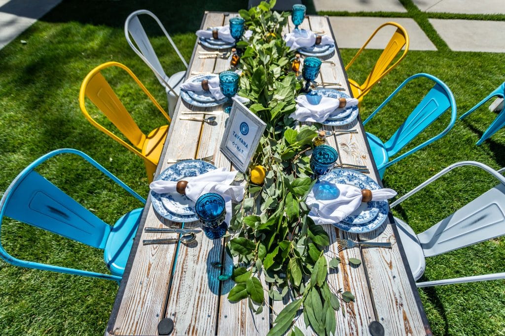 Blue, grey and yellow chair rentals, lemon leaves arranged down the center of the table, Casear Event Rentals Orlando, Central FL