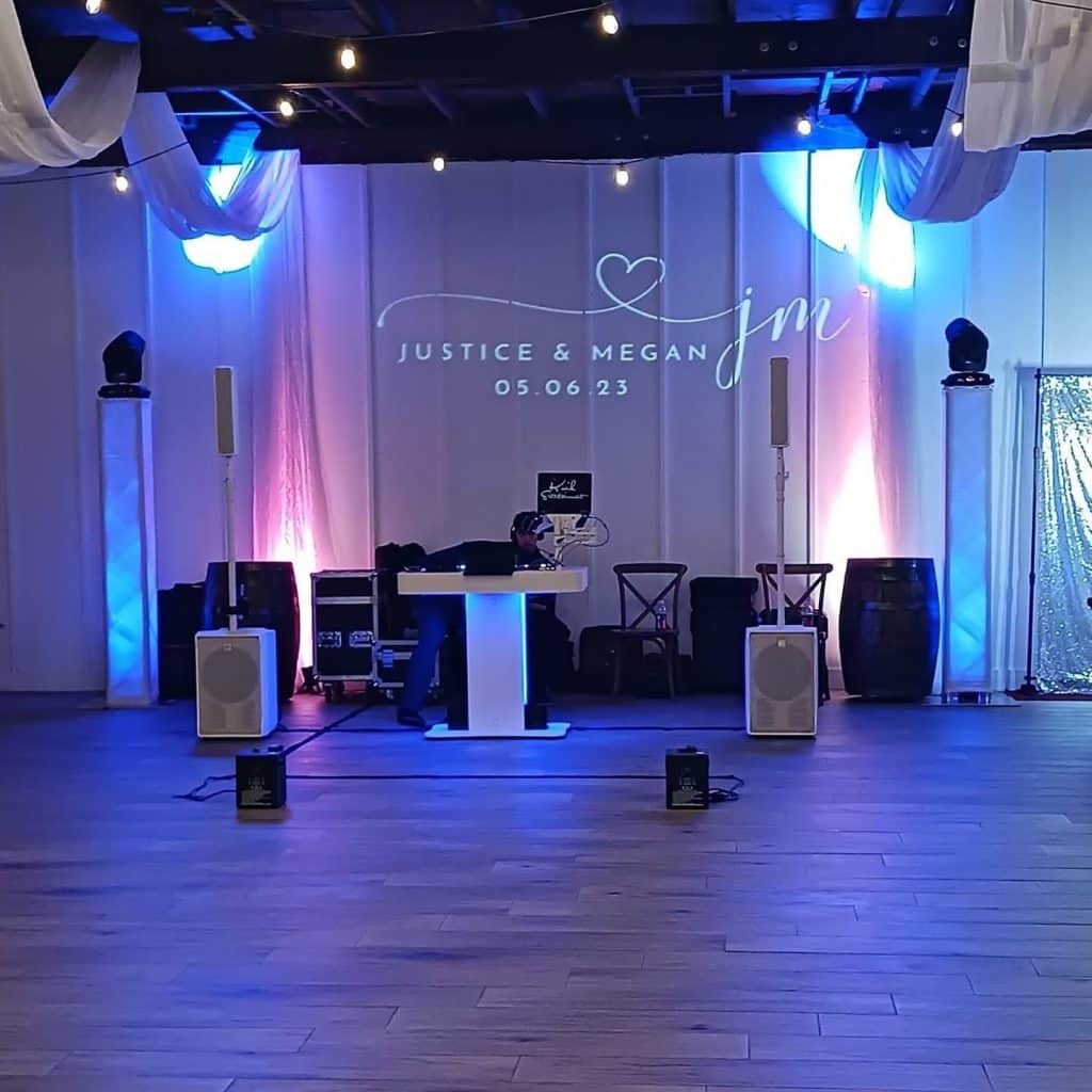 DJ set up with uplighting and dance floor, Kwik Entertainment
