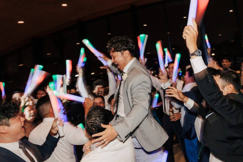 Dance party at a reception with colorful glow sticks being swung by guests, Alicia Frost Photography, Central FL