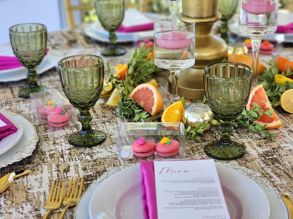 tables cape of white plates and chargers, menu cards, hot pink napkins, olive green glasses, fruit centerpieces, Orlando, FL