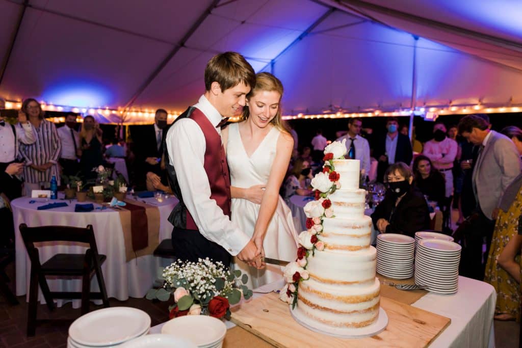 Bride and groom cutting into their wedding cake at their reception, Alicia Frost Photography, Central FL