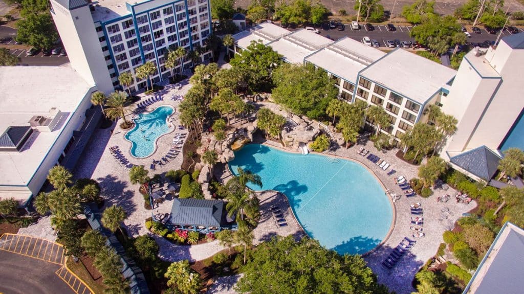 Aerial view of the property, towers surrounding several pools with lots of greenery, Central, FL