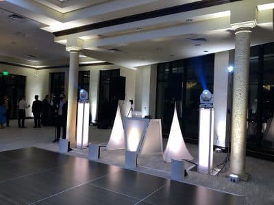 DJ Rey booth set up for a special event in a ballroom with uplighting, Central FL