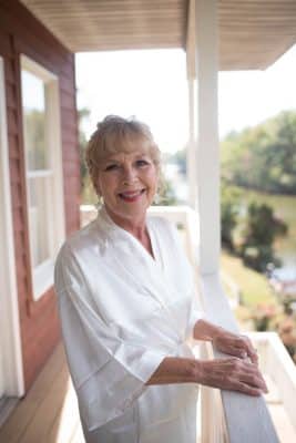 Mature woman on the porch in her wedding robe in full make up, Central, FL