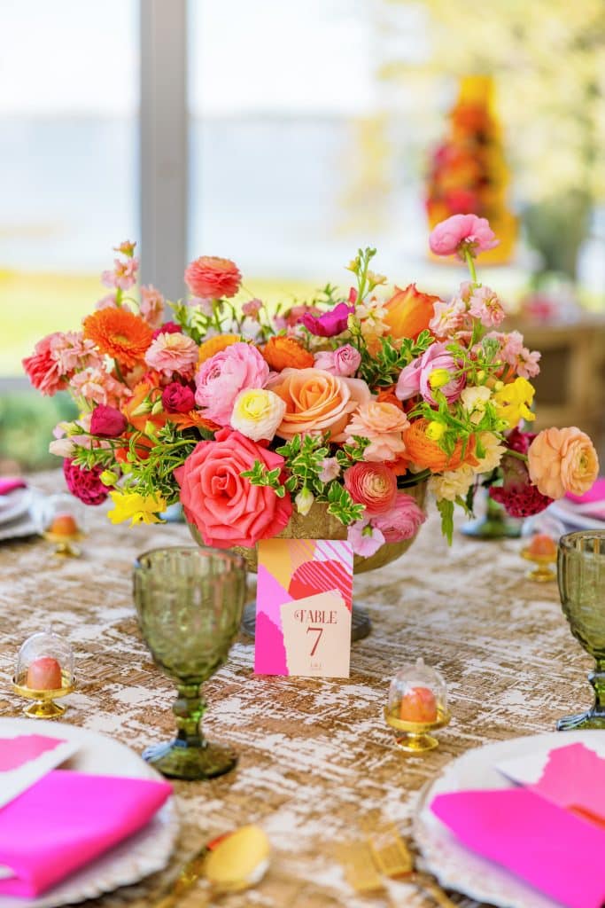 Centerpiece on a reception table, with spring colored flowers, of pink, yellow, orange and red, Orlando, FL