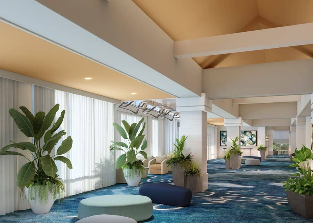 Delta by Marriott Orlando Celebration hallway with blue carpet, large potted plants, comfortable lounge furniture, vaulted ceilings, Central, FL