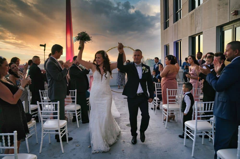 Sunset ceremony with the bride and groom exiting to their reception and adored by guests, Kwik Entertainment