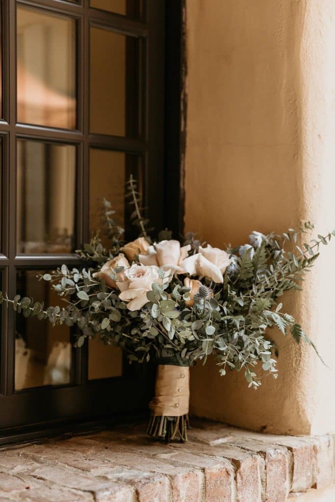 Flower bouquet set up on a window sill with exposed brick, Central FL, JF Events and Flowers