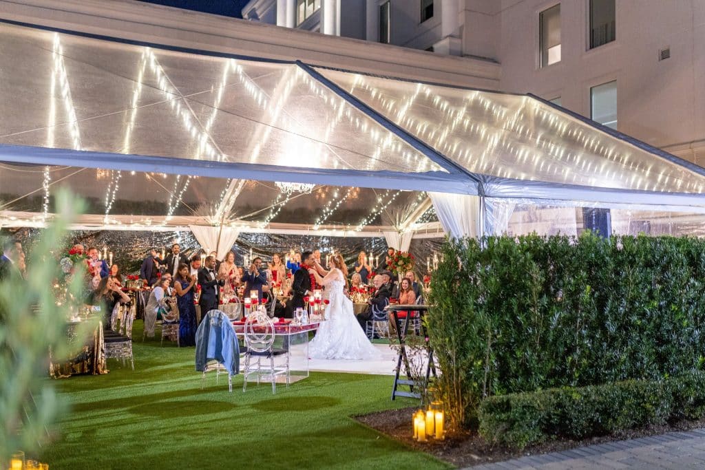outdoor clear tent, greenery, bride and groom on the dance floor, orlando, fl