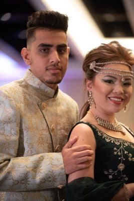 Couple posing for a photo in their wedding attire, bride is wearing head jewelry and a necklace, Central, FL