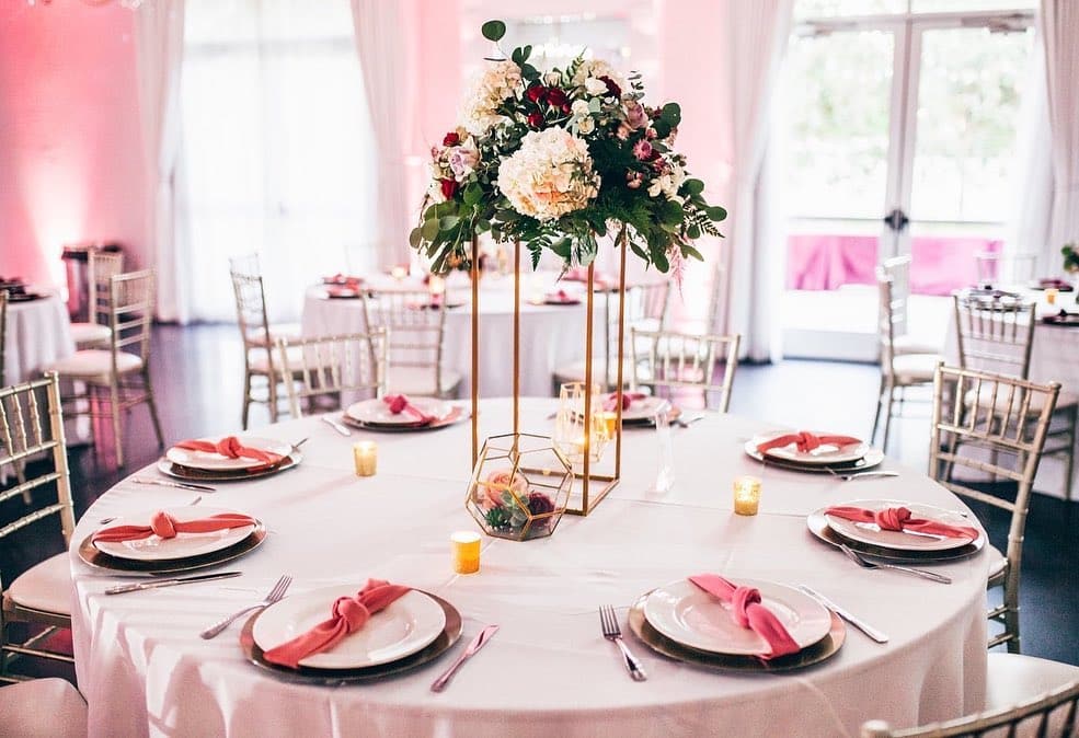 Pink themed special event with gold chargers, white plates, pink napkins, tall centerpiece pink flowers with greens, LaBellaRose Ballroom, Central FL