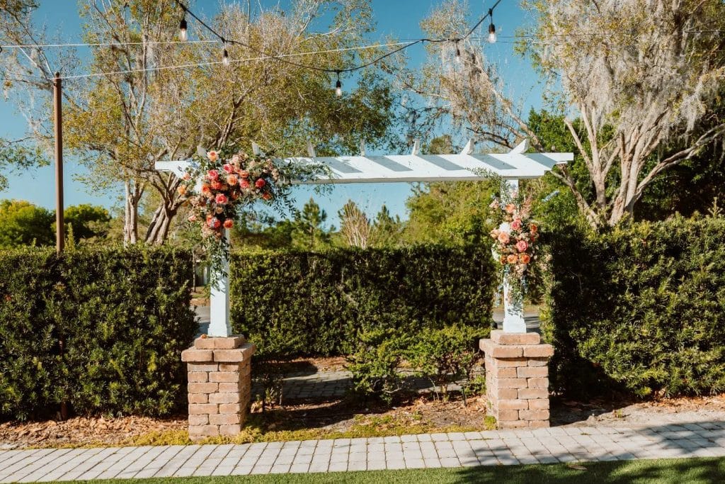 Outdoor garden area of the venue, brick walkway with shaped hedges and an alter for outside ceremonies, Central FL