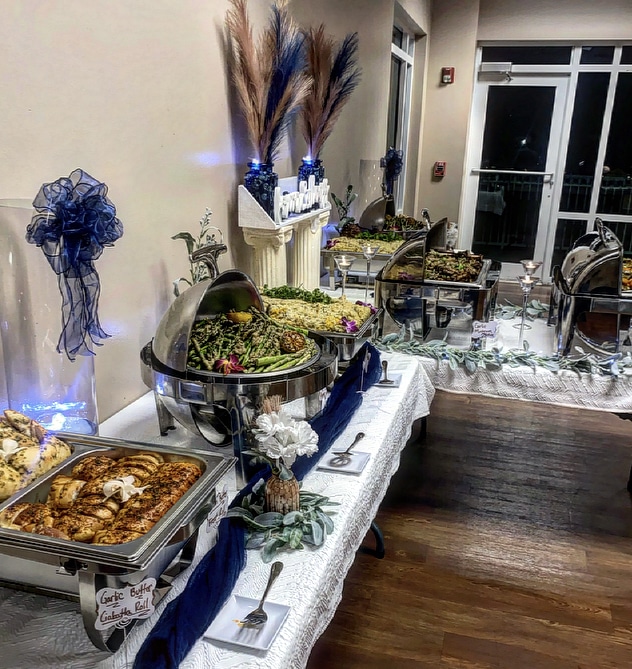 Close up view of T-shaped catering set up, with chicken, green beans, mac and cheese and other accompaniments, Central FL