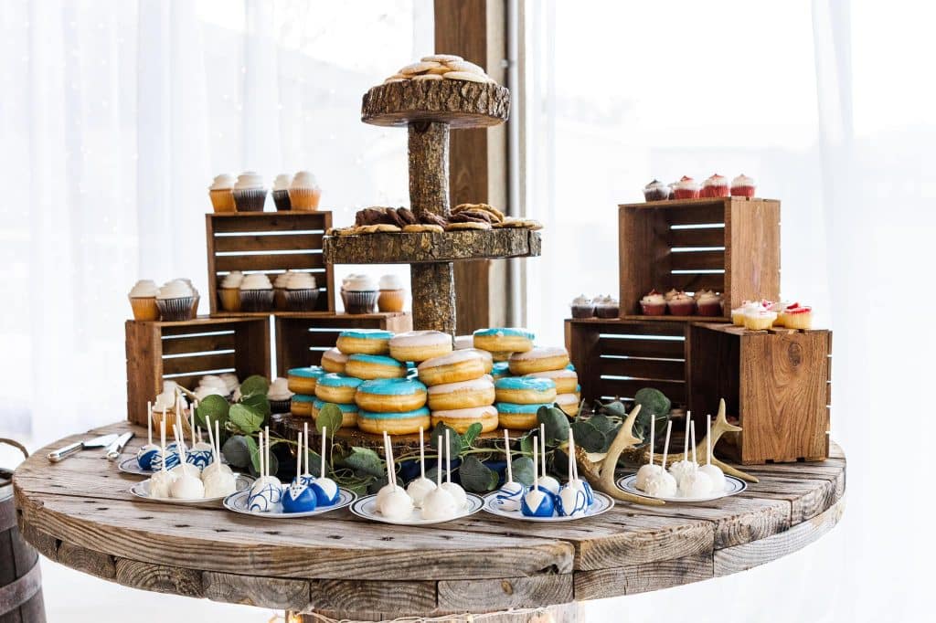 Dessert display on wooden crates, donuts, cake pops and cupcakes, on a round table, Orlando, FL