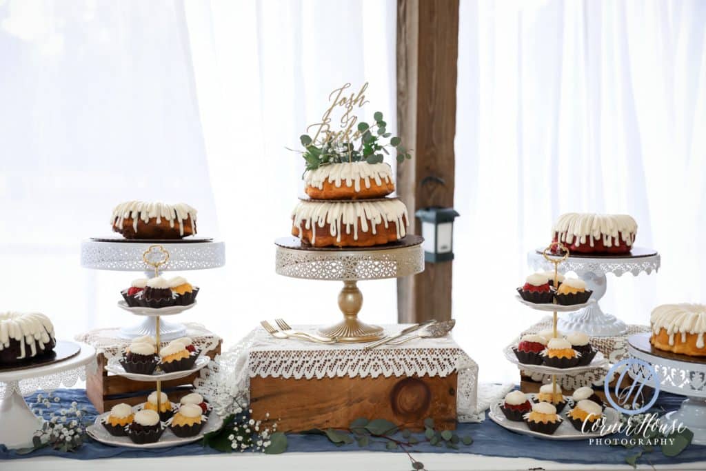 Dessert display of mini and large bundt cakes on a variety of cake stands, Orlando, FL