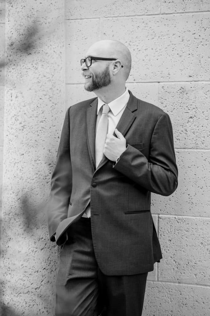Black and White photo of a man in a dark suit, looking to his right before the wedding, Central FL
