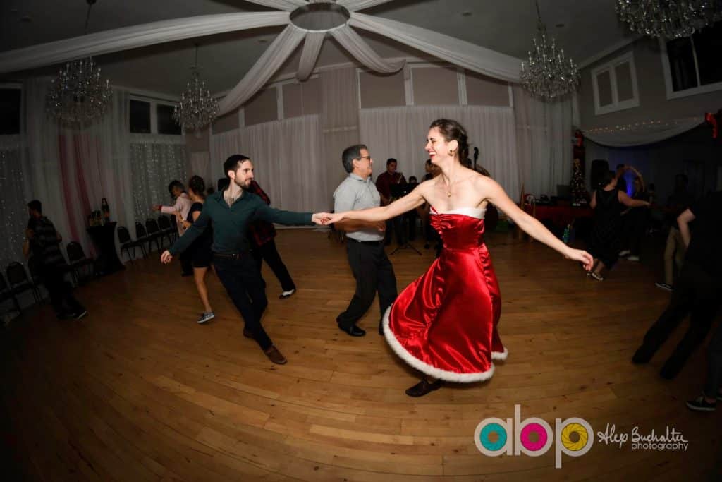 Couple dancing at a special event, woman in a bright red dress, man in all black, Vintage Dance Company, Central FL