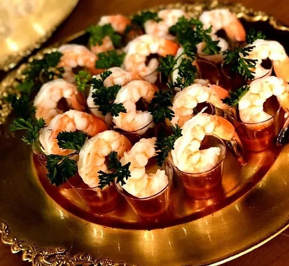 Shrimp cocktail shooters on a red plate, served on a gold platter, Creations Cuisine Inc, Central FL