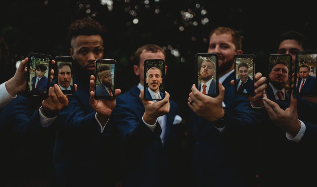 Groomsmen holding their cell phones, each with a photo of themselves on it for the camera to capture, Ashley Krug Photography, Central FL