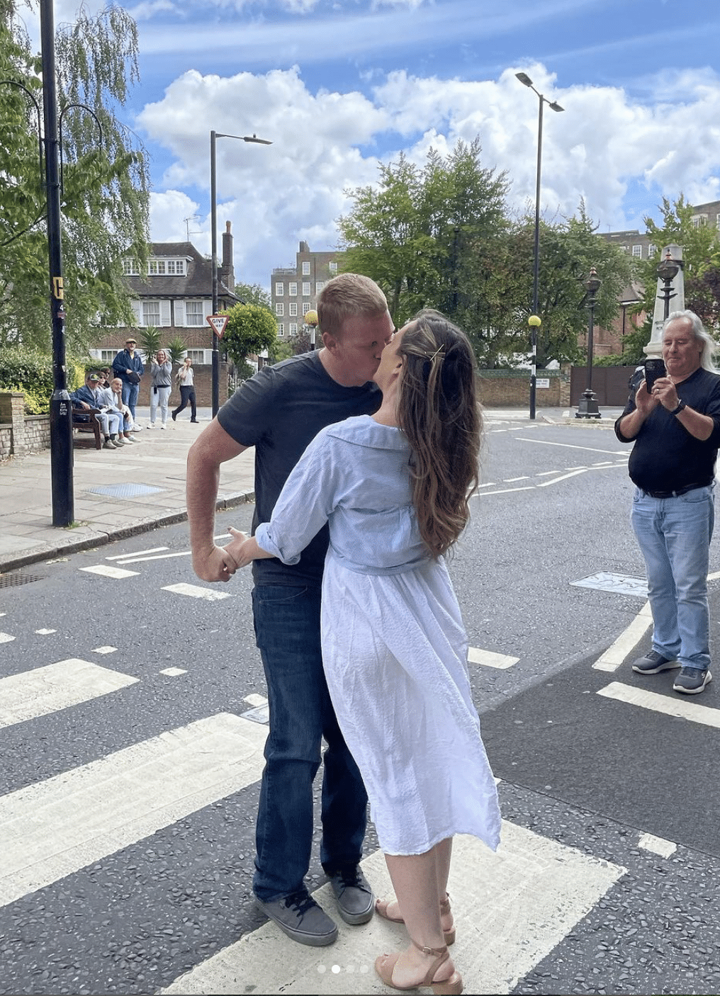 couple kisses on famous road in london in abbey road marriage proposal