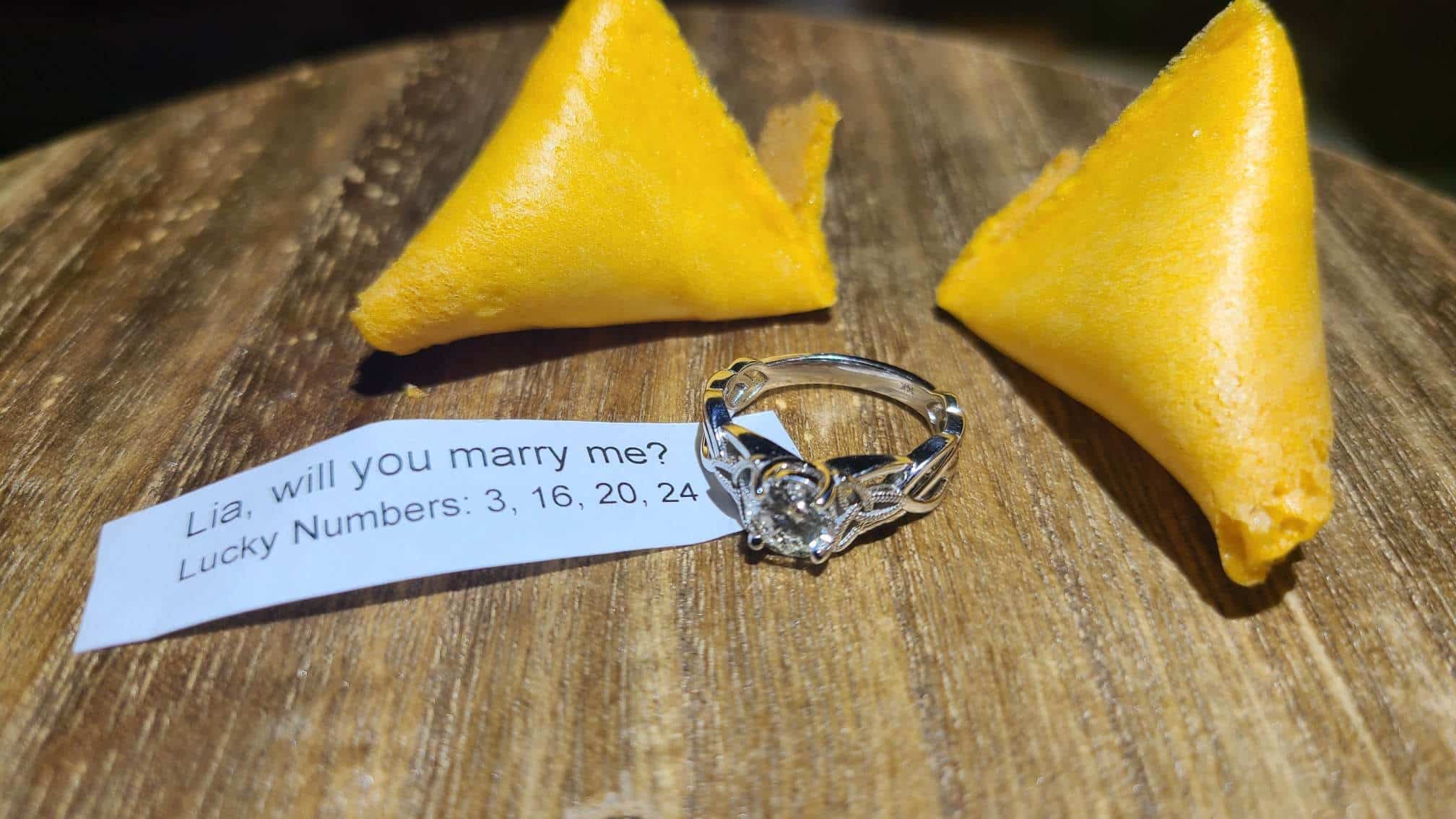 ring and cookie with paper in fortune cookie marriage proposal