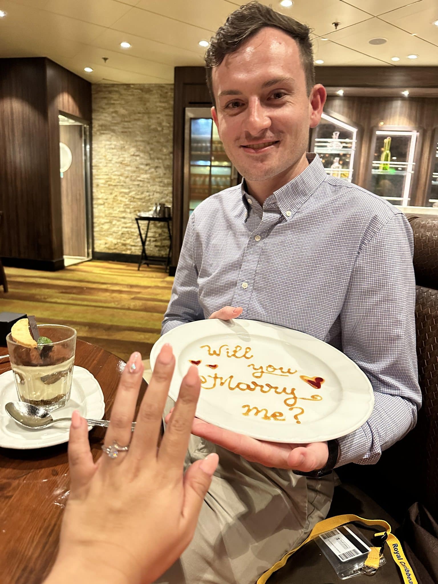man holds plate that says will you marry me 