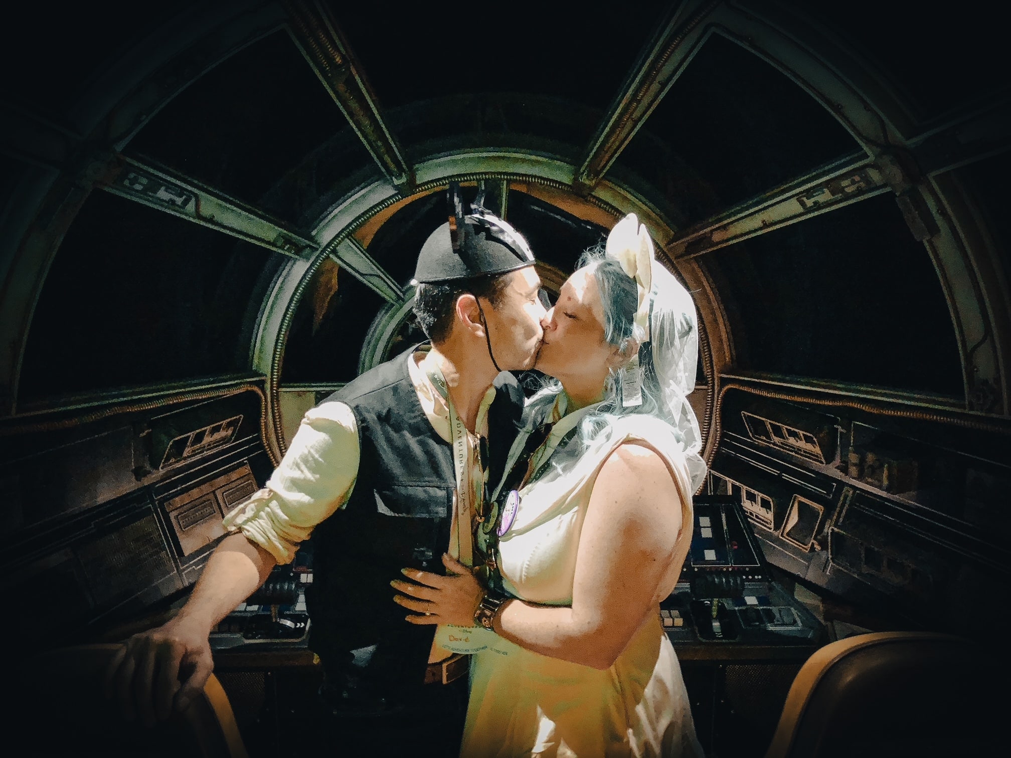 couple kisses in themed outfits in star wars marriage proposal