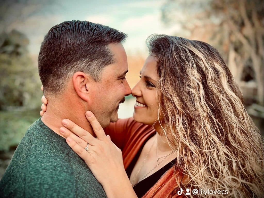 man and woman pose together touching noses