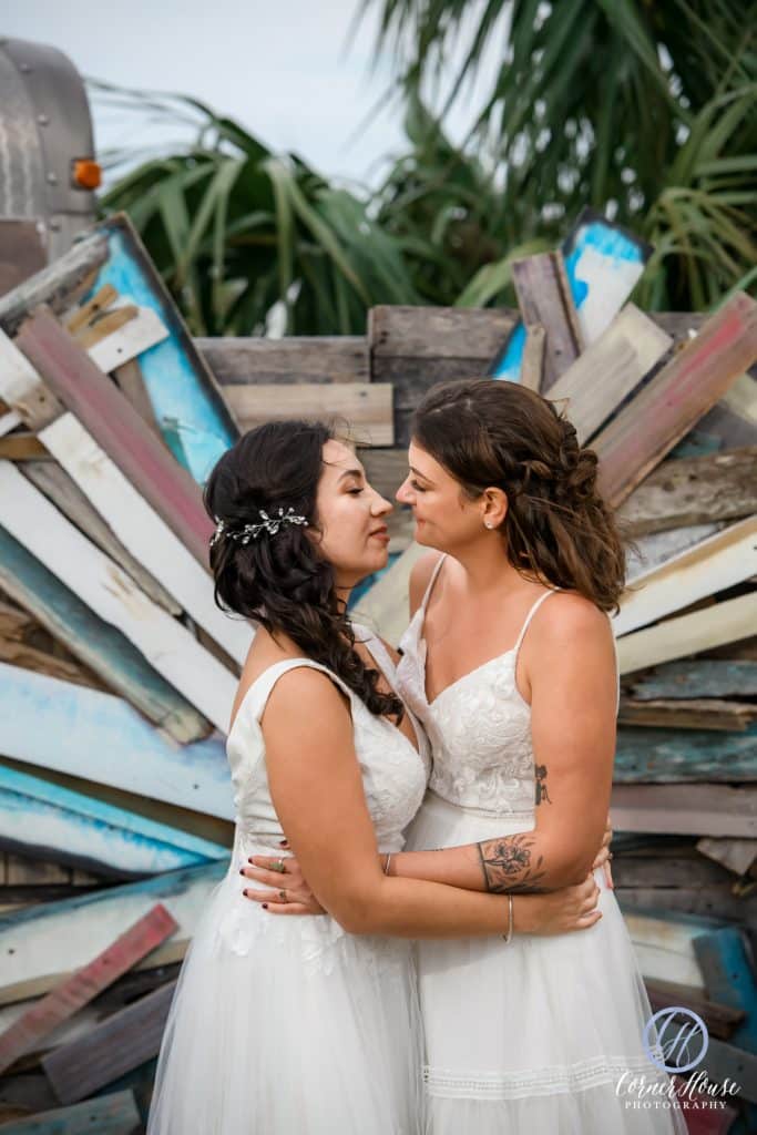 Two Brides embracing before a kiss, outdoors on their wedding day, Orlando, FL